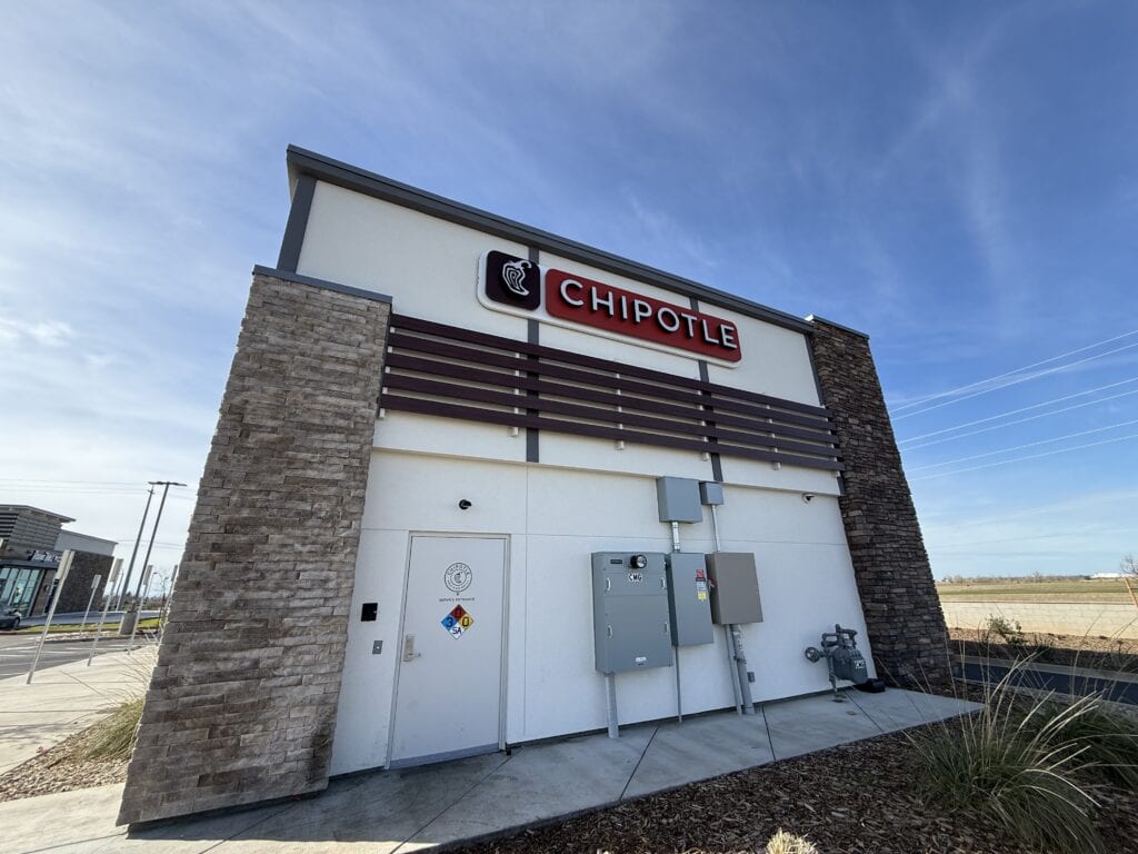 Stone veneer columns and panel siding on Chipotle commercial building