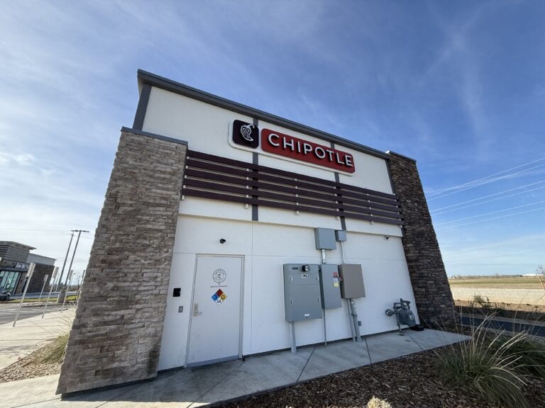 Stone veneer columns and panel siding on Chipotle commercial building