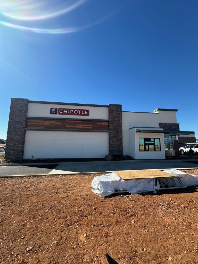 Stone veneer columns and panel siding on Chipotle commercial building
