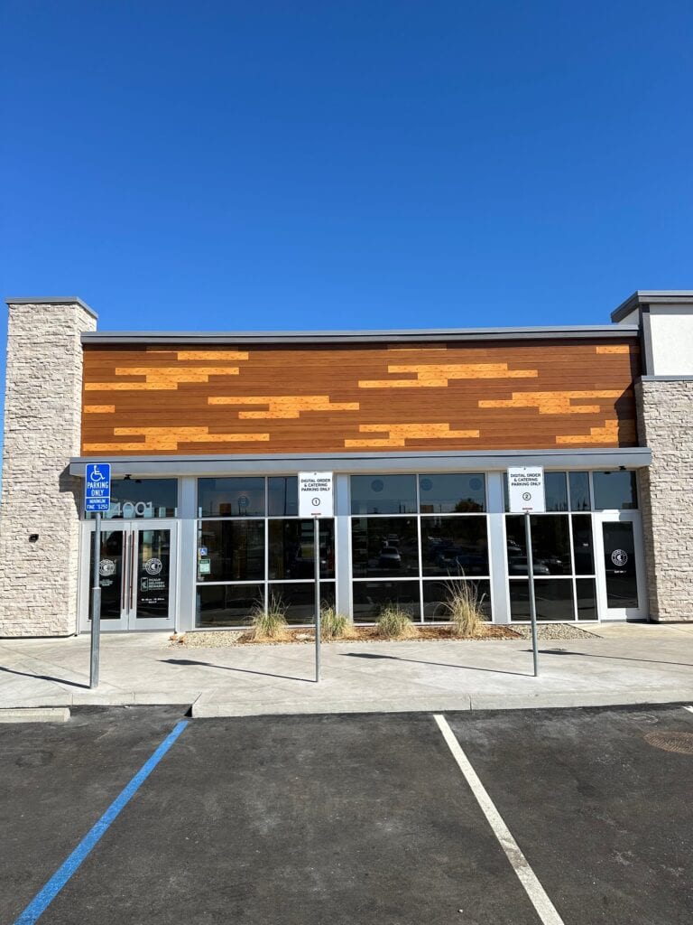 Stone veneer columns and panel siding on Chipotle commercial building